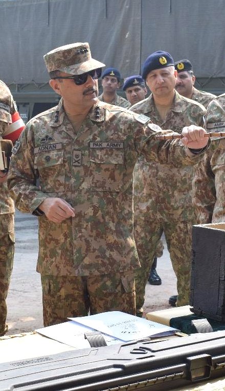 Lt Gen Syed Muhammad Adnan inspecting a precision rifle